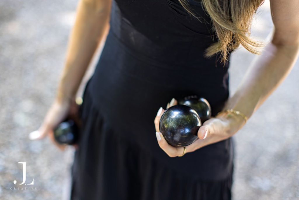 Close-up of a guest holding boules balls during a outdoor game at Knepp Estate.