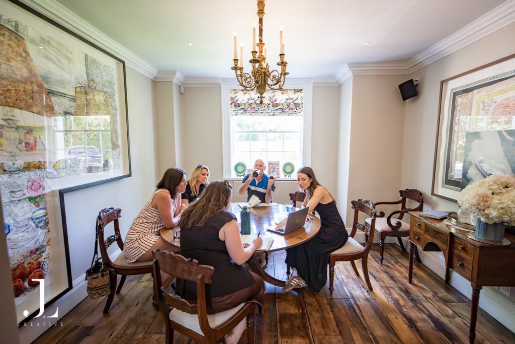Attendees taking part in a workshop round table session indoors at Knepp Estate.