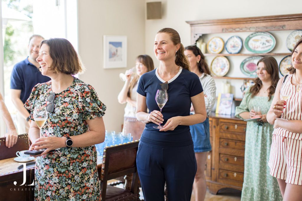 Guests enjoying French Bloom sparkling wine during Belmond's luxury hospitality retreat indoors.