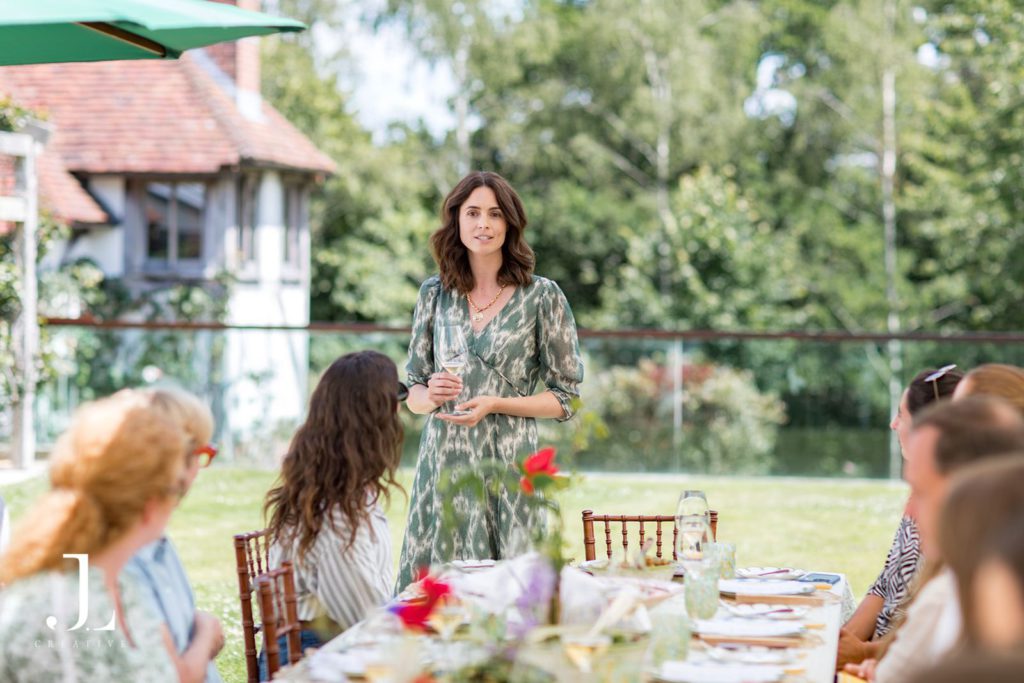 Host speaking during an al fresco lunch at Belmond's Secret Retreat in Sussex.