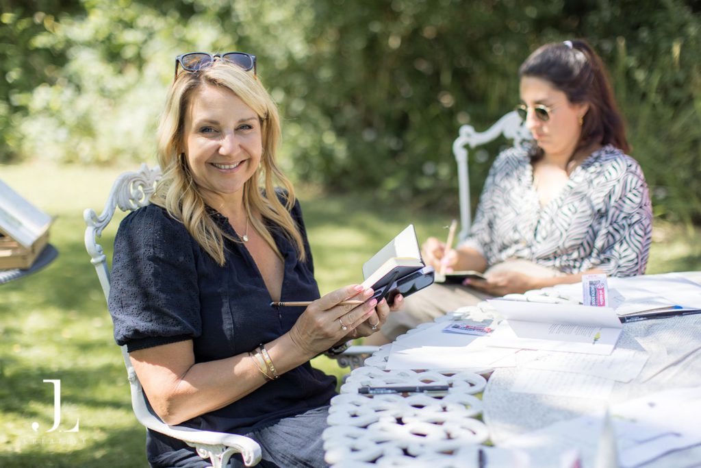 Guest taking notes during an outdoor workshop at Belmond's Knepp Estate retreat.