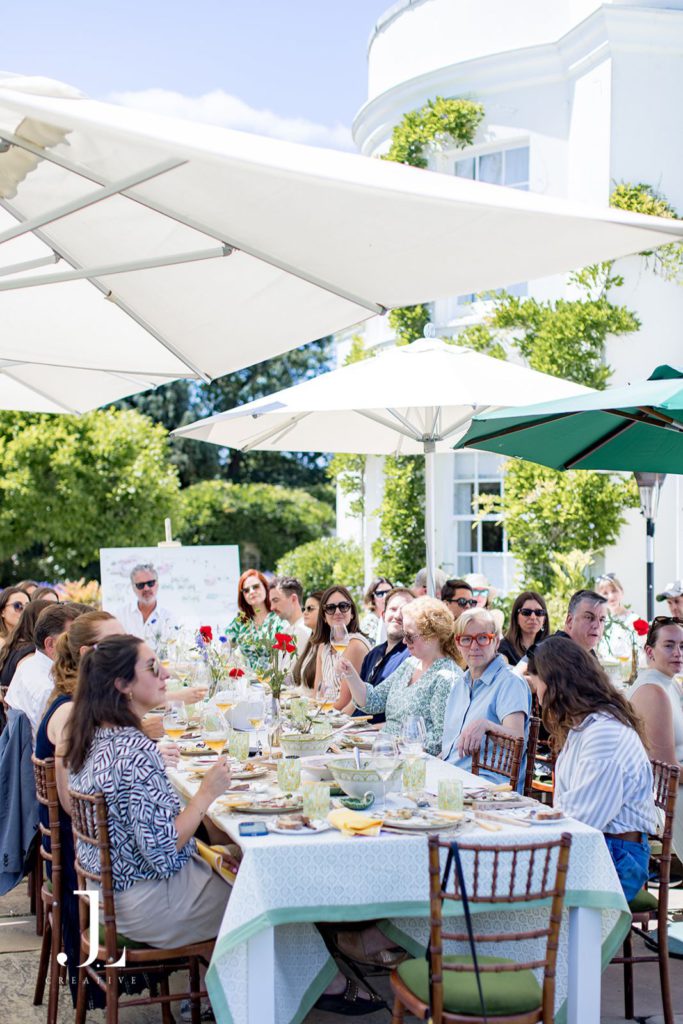 Attendees enjoying an al fresco group lunch on the terrace at Knepp Estate.