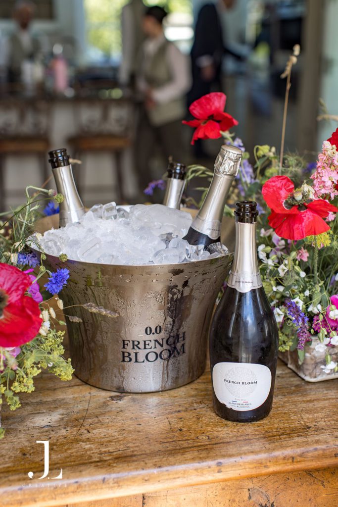 Bottles of French Bloom non-alcoholic sparkling wine chilled in an ice bucket.