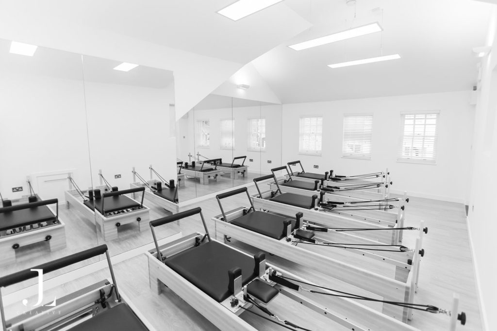 Wide angle view of empty reformer studio setup for Pilates studio photography in Surrey.