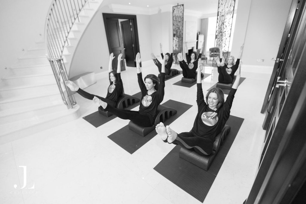 Overhead shot of a group class on arc barrels during Pilates studio photography in Surrey.